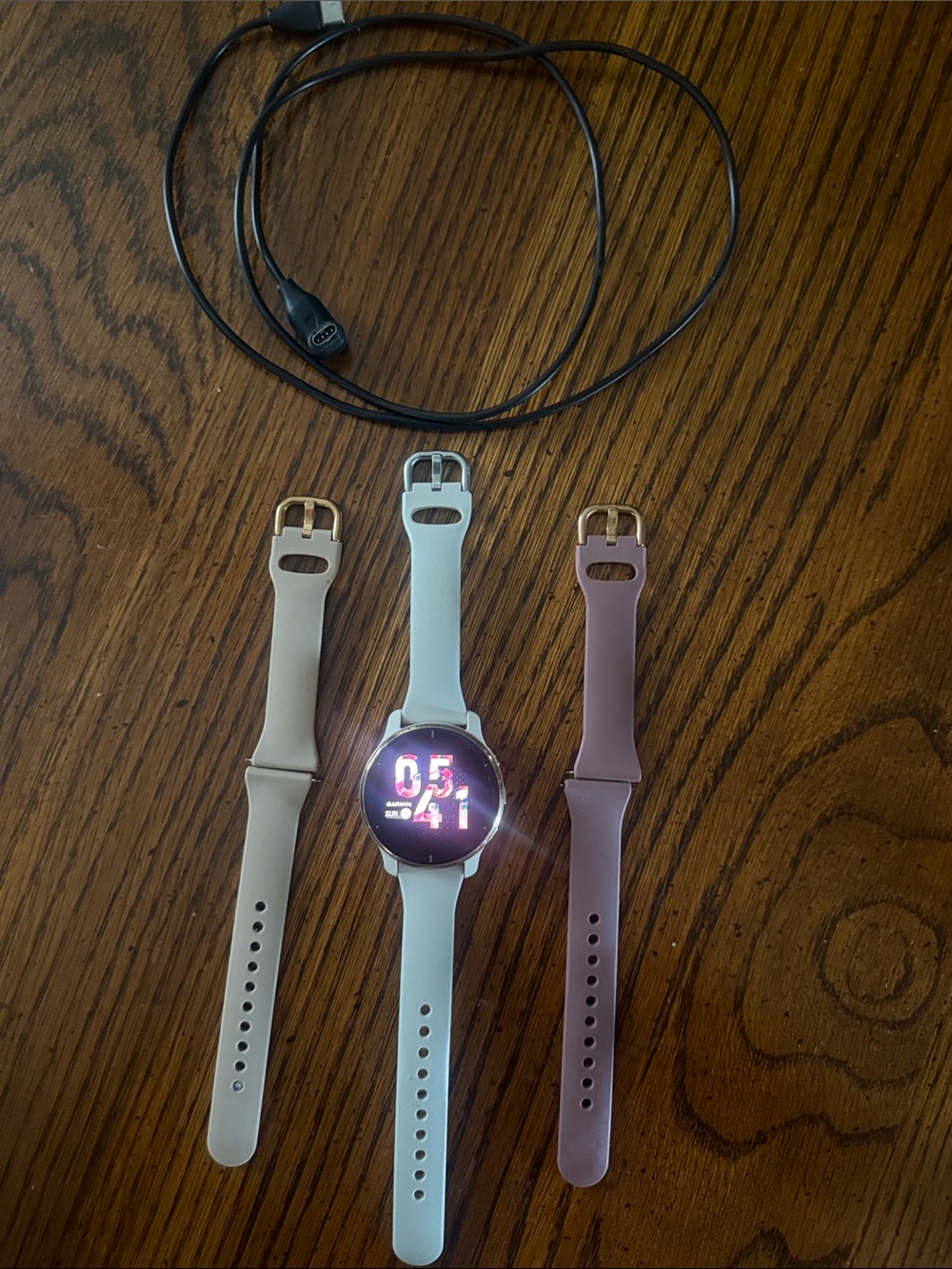 Garmin Venu 2 Plus smartwatch with white, cream, and mauve interchangeable bands